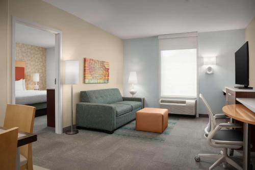 a living room with a couch and a bed at Home2 Suites by Hilton Baltimore/White Marsh in White Marsh