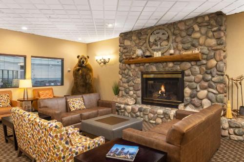 a living room with a large stone fireplace at Hampton Inn Kalispell in Kalispell
