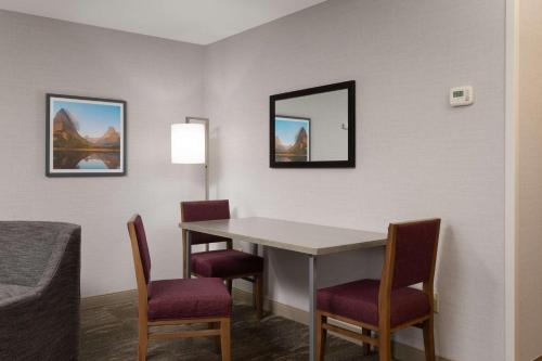 a room with a table and chairs and a mirror at Hampton Inn Kalispell in Kalispell