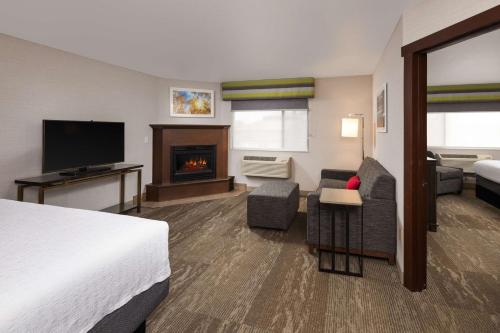 a hotel room with a bed and a fireplace at Hampton Inn Kalispell in Kalispell