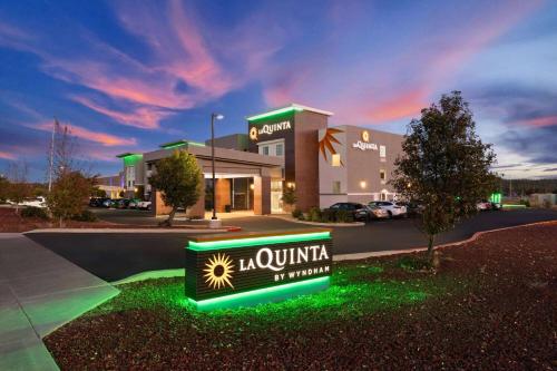 a hotel with a neon sign in front of a building at La Quinta by Wyndham Williams-Grand Canyon Area in Williams