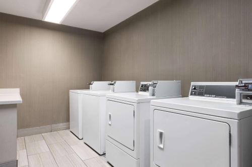 a row of white washers and dryers in a room at La Quinta by Wyndham Williams-Grand Canyon Area in Williams