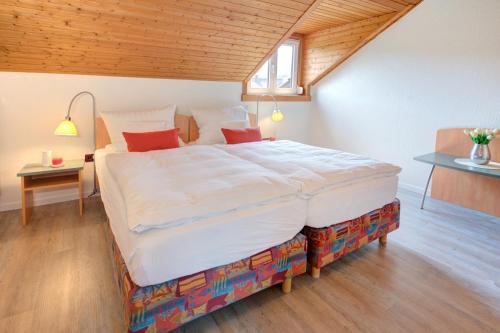 a bedroom with a large bed in a room at Apartment Landhotel Zum Storchennest in Bann
