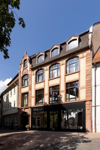 a large brick building with windows on a street at Studio 9 in Fulda