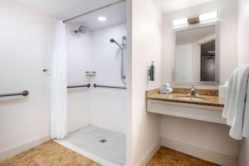 a bathroom with a shower and a sink at Hilton Vacation Club The Cove on Ormond Beach in Ormond Beach