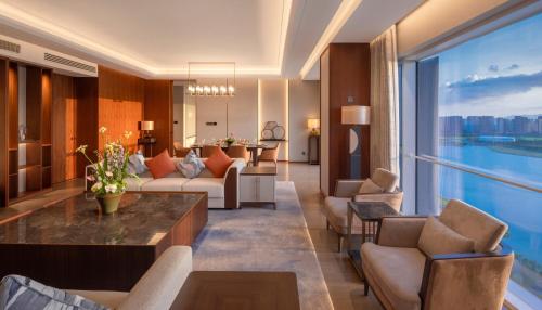 a living room with a couch and a table at Suzhou International Conference Hotel in Suzhou