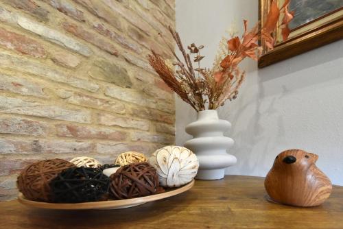 a table with two plates of food and a vase at Belvedere Campanon in Nizza Monferrato