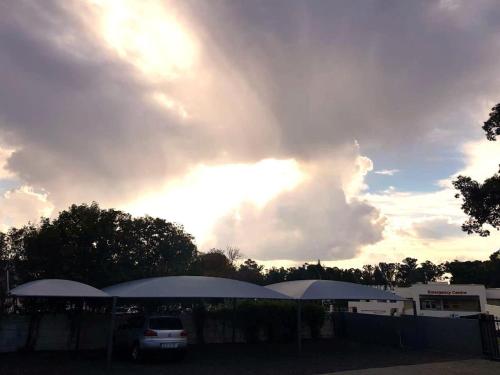 a cloudy sky with a car parked in a parking lot at MediStay Self Catering Accommodation in Bethlehem