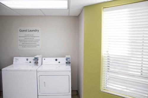 a kitchen with a dishwasher and a window with a guest laundry sign at Holiday Inn Express & Suites Kings Mountain - Shelby Area by IHG in Kings Mountain