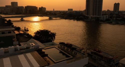 a view of a river with a bridge in a city at The StandardX, Bangkok Phra Arthit in Bangkok