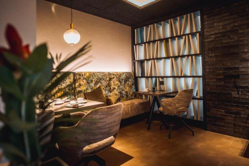 a dining room with a table and chairs and a window at Hotel Ederstrand in Frankenberg