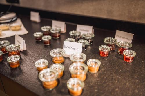a bunch of small jars of honey on a table at Hotel Ederstrand in Frankenberg