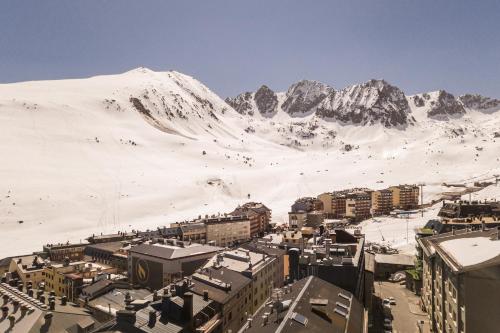 a city with a snowy mountain in the background at Pierre & Vacances Pas de la Casa Alaska in Pas de la Casa