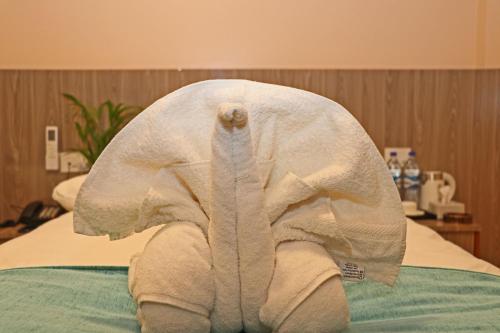 a towel elephant sitting on top of a bed at Hotel Resunga Arjun in Kathmandu