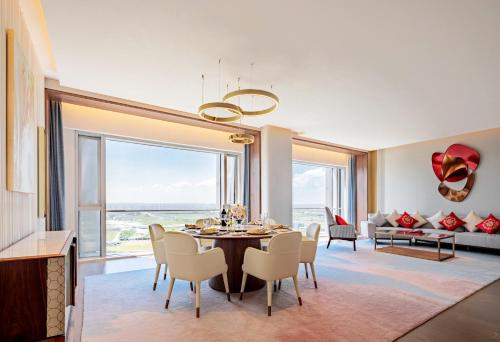 a dining room with a table and chairs and a large window at Suzhou International Conference Hotel in Suzhou