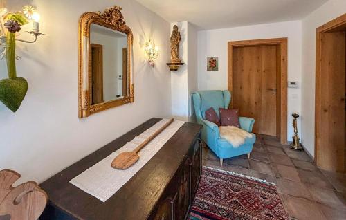 a living room with a mirror and a blue chair at Ferienwohnung In Dorfbeuern in Dorfbeuern
