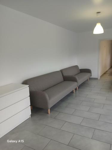 a couch in a room with a white wall at Appartement Almadrava Roses in Roses