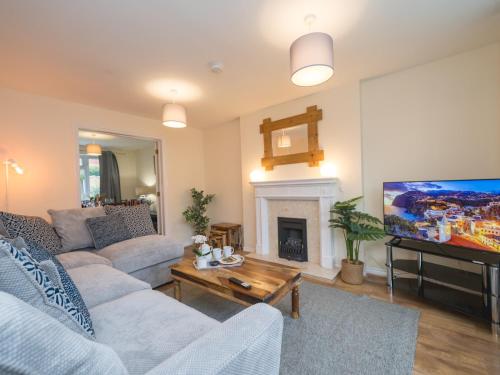 a living room with a couch and a tv at 3 bedroom detached homesleeps 5 in Shrewsbury - Pass the Keys in Bicton