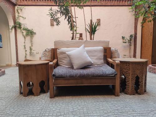 a couch with a pillow sitting on a patio at Kemet House in Luxor