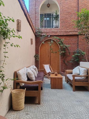 a patio with couches and a table and a building at Kemet House in Luxor