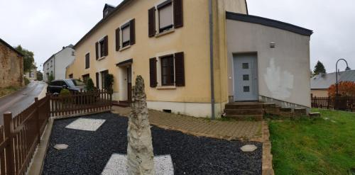 a house with a fence in front of it at Cosy House in Dippach