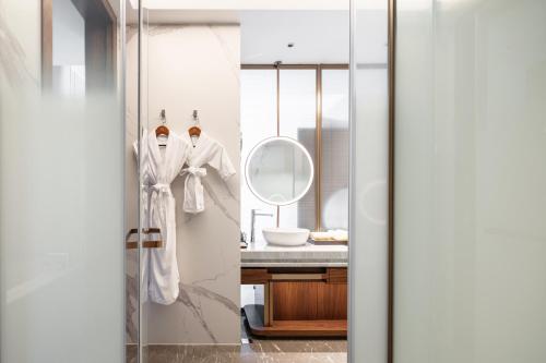 a bathroom with a sink and a mirror at Suzhou International Conference Hotel in Suzhou