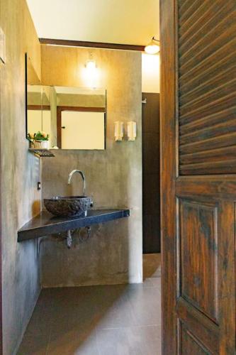 a bathroom with a sink and a mirror at Elephant Camp Maerim in Ban Thung Pa Haeo