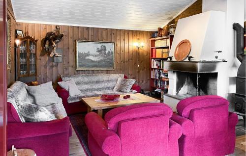 a living room with pink chairs and a table at Nice Home In Oppdal With Sauna in Oppdal
