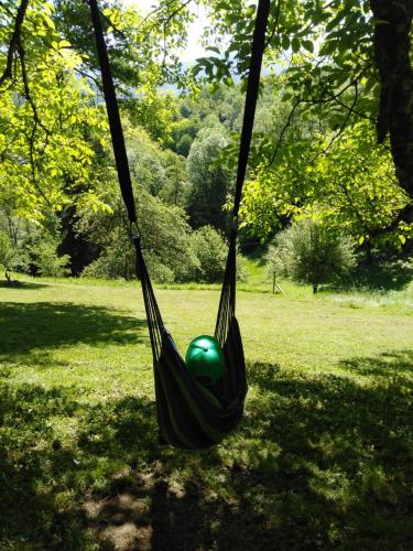 a green ball in a hammock in a park at D'tente sky lodge in Massat