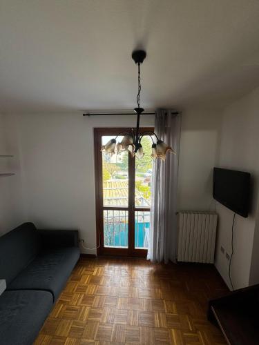 a living room with a couch and a window at Le camere del Sal8 al Parco in Villasanta