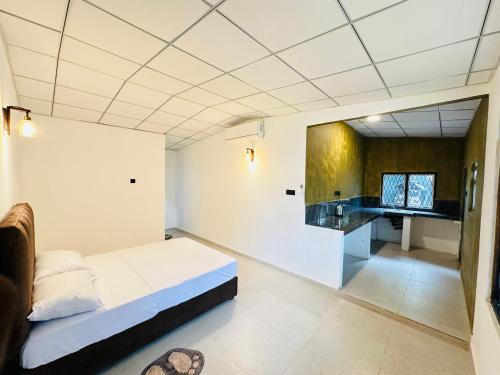 a bedroom with a bed and a sink in it at Ceylonia Ape Gedara in Kochchikade