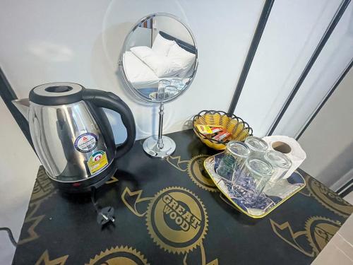 a coffee maker and a mirror on a table at The Camp Chiangkhan in Loei