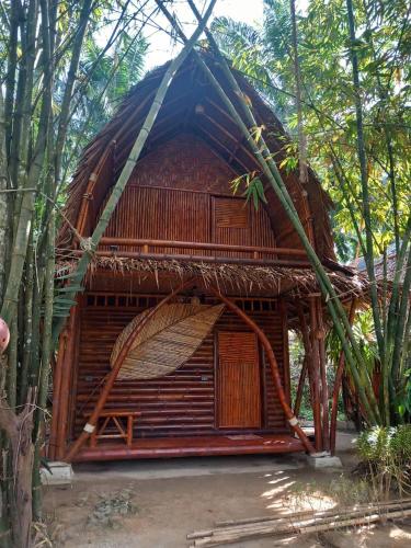 a bamboo hut with a thatched roof in the woods at KRABI BAMBOO KINGDOM at AOLUEK PARADISE in Ao Luk