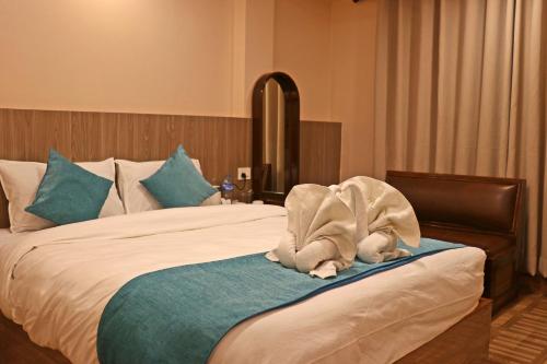 a bed with a towel animal sitting on top of it at Hotel Resunga Arjun in Kathmandu