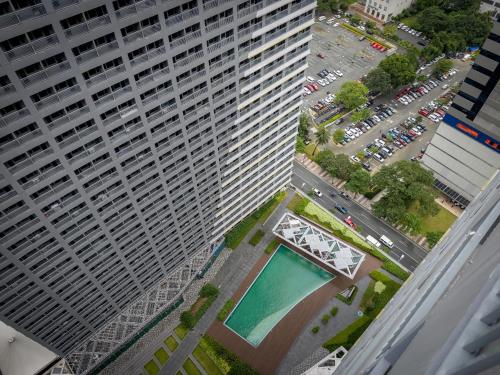 an aerial view of a large building with a pool at GemstoneBR in SMDC Fame Residences in Manila
