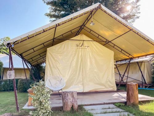 a large tent with a chair in a yard at The Camp Chiangkhan in Loei