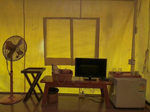 a room with a desk with a computer and a fan at The Camp Chiangkhan in Loei