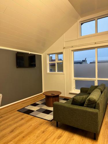 a living room with a couch and a table at Vík Inn in Vík