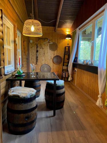 a room with a table and a bunch of barrels at Ferienhaus Bussard in Gammelsbach