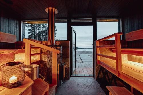 ein Zimmer mit Kamin und Blick auf das Meer in der Unterkunft Saunamäki - Frida in Salo
