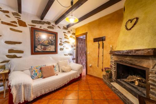 a living room with a couch and a fireplace at Picachico in Laroya