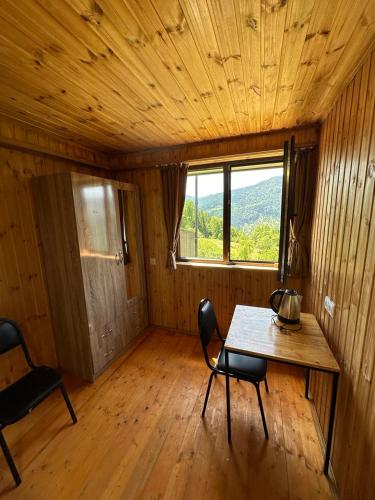 a room with a table and chairs and a window at Nika Hotel and Club in Chʼanchʼkhalo