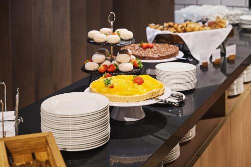 a buffet with a table with desserts and food at Holiday Inn Express Lublin by IHG in Lublin
