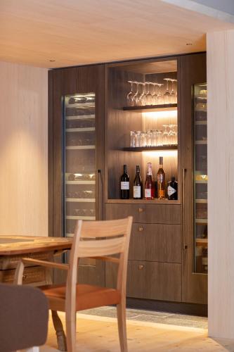 a dining room with a table and wine glasses at Alpina Lech - Geborgen in den Bergen in Lech am Arlberg