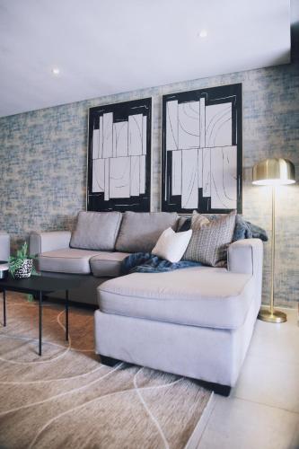 a living room with a white couch and a table at Dolce vita luxurious apartment in Umhlanga