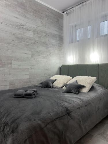 a bedroom with a large bed with pillows on it at Vista apartment 4 in Choszczówka
