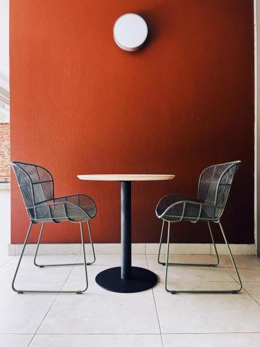 two chairs sitting around a table in a room at Dolce vita luxurious apartment in Umhlanga