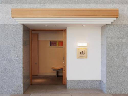 an open door into a building with a table at ART HOTEL Kashima Central in Kamisu