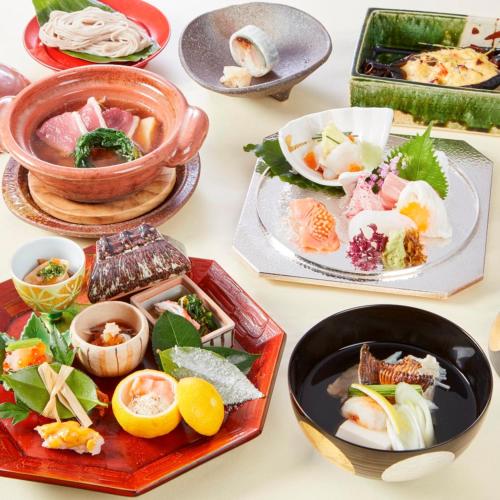 a table with plates of food and bowls of food at Kobe Seishin Oriental Hotel in Kobe
