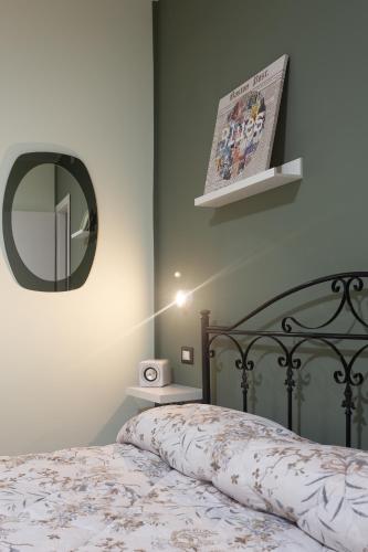 a bedroom with a bed with a mirror on the wall at BB Diesis in Ferrazzano